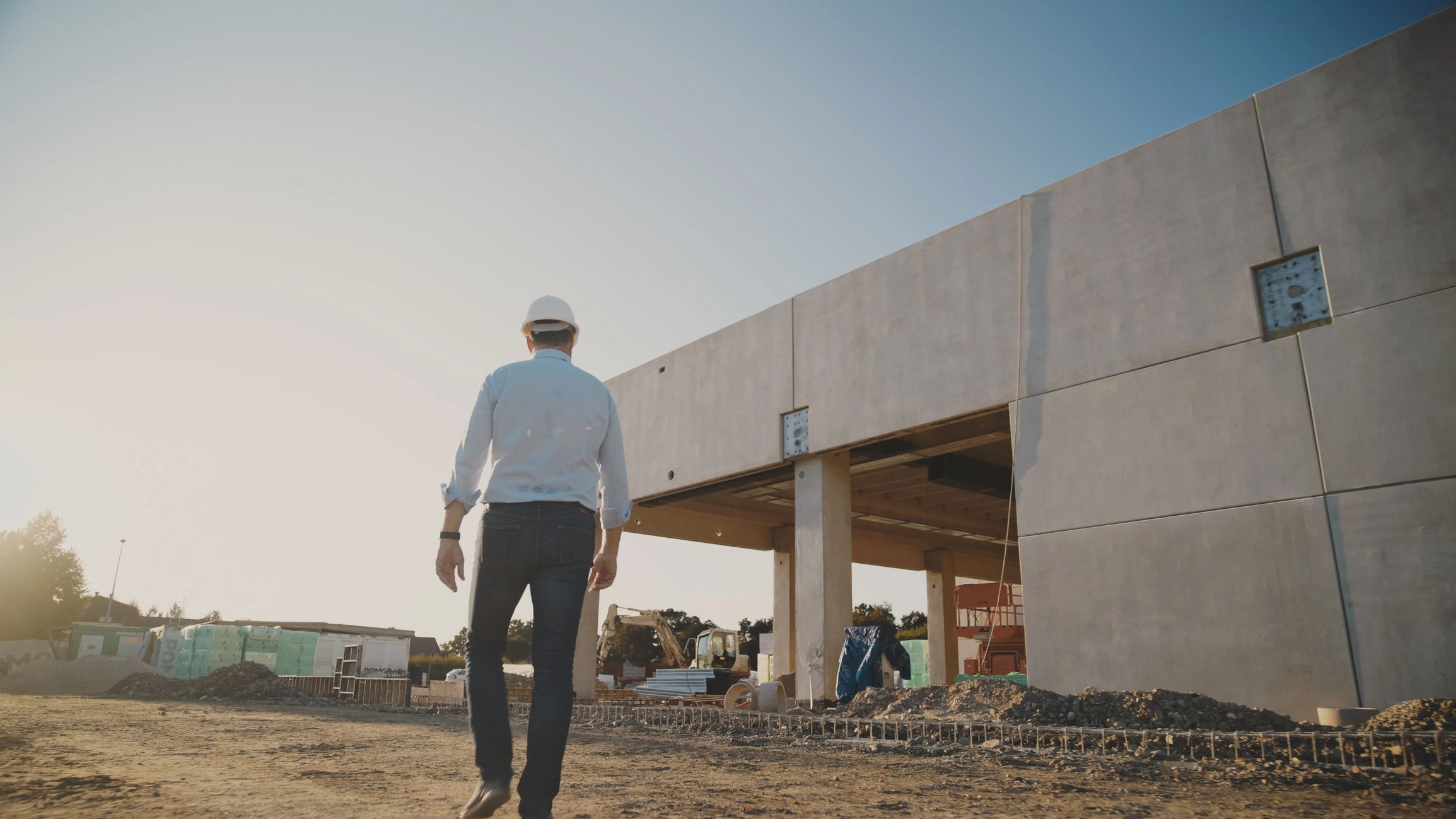 Confident male project manager with protective headwear.
